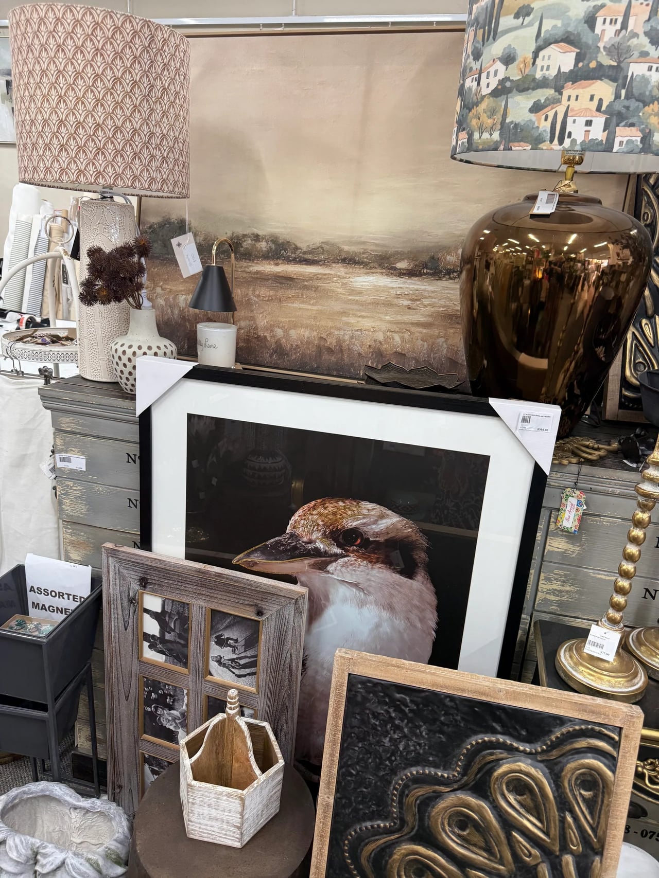 Showroom display of lamps, framed prints and giftware including a kookaburra photograph